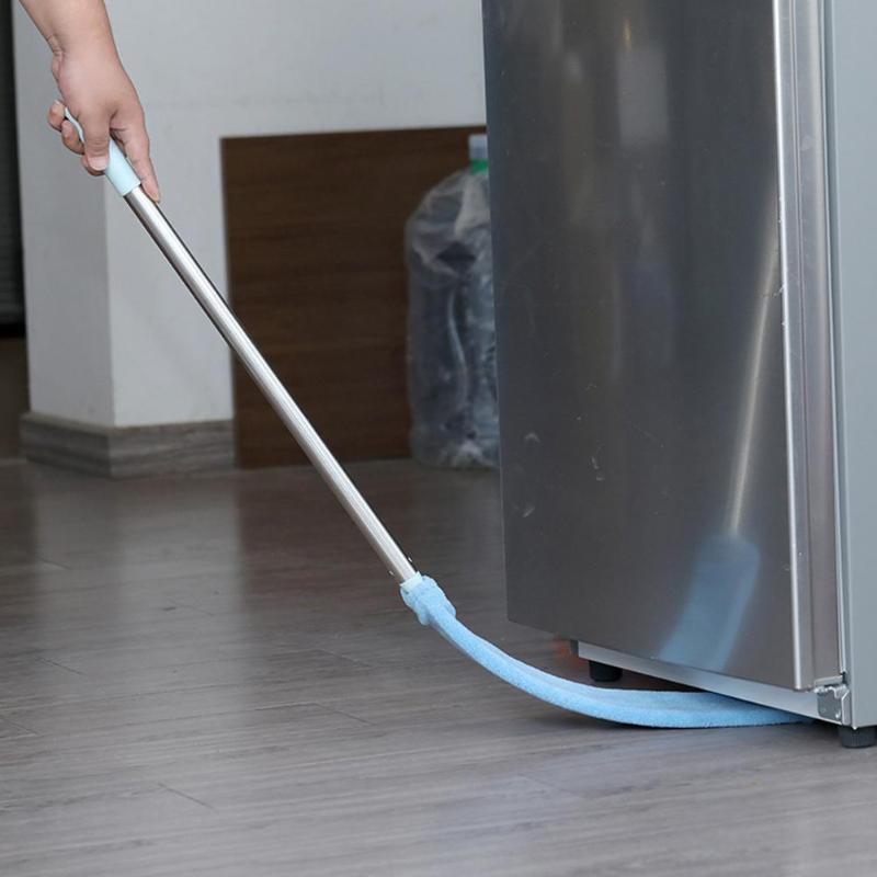 Pessoa usando ferramenta com cabo longo para limpar a parte inferior de um eletrodoméstico de inox