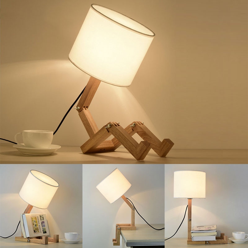 Luminária de mesa com base articulada em madeira e cúpula branca, criando ambiente aconchegante