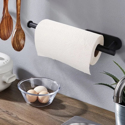 Suporte preto moderno para papel toalha na parede da cozinha com utensílios de madeira e ovos em tigela de vidro