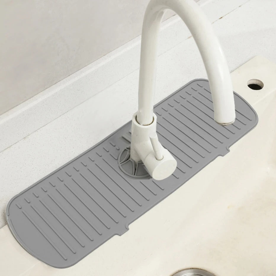 Bancada de pia branca com torneira curva branca e protetor de silicone cinza